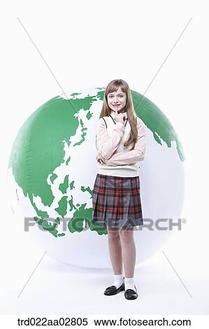 a student in uniform posing in front of a globe View Large Photo Image Stock Photography - a student in uniform posing in front of a globe. Fotosearch