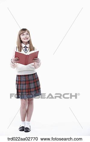 a student in uniform reading a book on white background View Large Photo Image Stock Image - a student in uniform reading a book on white background. Fotosearch