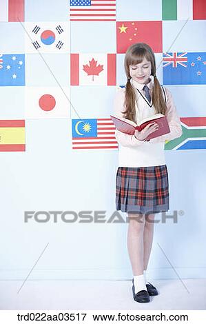 a student in uniform reading in front of international flags View Large Photo Image Stock Photo - a student in uniform reading in front of international flags. Fotosearch