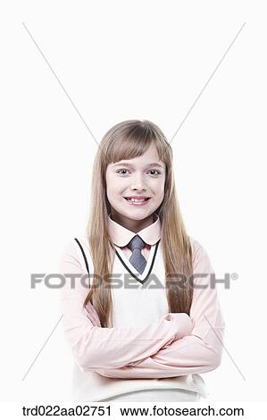 Stock Image - a student in uniform standing arms crossed on white background. Fotosearch