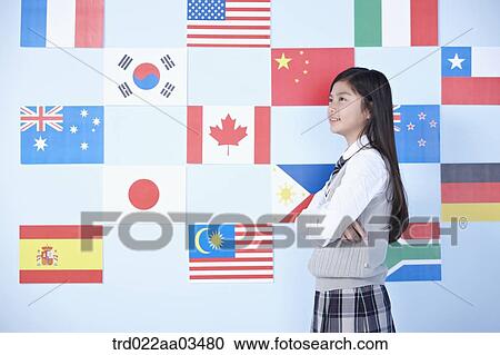a student in uniform standing in front of international flags View Large Photo Image Stock Image - a student in uniform standing in front of international flags. Fotosearch