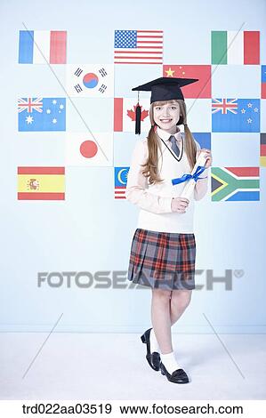 a student in uniform standing in front of international flags with graduation hat View Large Photo Image Stock Photo - a student in uniform standing in front of international flags with graduation hat. Fotosearch