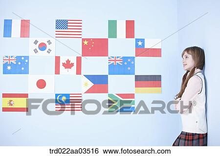 a student in uniform standing next to international flags View Large Photo Image Stock Photograph - a student in uniform standing next to international flags. Fotosearch