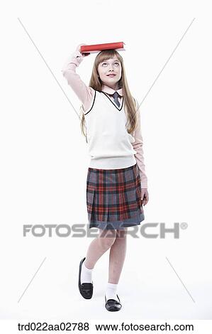 a student in uniform with a book on head View Large Photo Image Stock Photo - a student in uniform with a book on head. Fotosearch