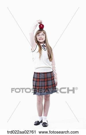 a student in uniform with an apple on white background View Large Photo Image Stock Image - a student in uniform with an apple on white background. Fotosearch