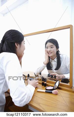 a student putting on make up View Large Photo Image Stock Photo - a student putting on make up. Fotosearch