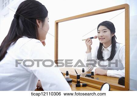 a student putting on make up View Large Photo Image Stock Photograph - a student putting on make up. Fotosearch