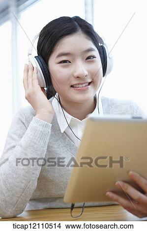 Picture - a student self learning using tablet PC. Fotosearch