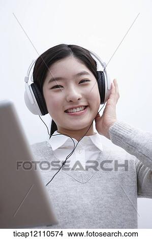 Picture - a student self learning using tablet PC. Fotosearch