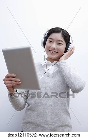 Stock Image - a student self learning using tablet PC. Fotosearch