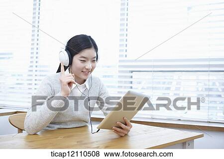 Stock Photo - a student self learning using tablet PC. Fotosearch