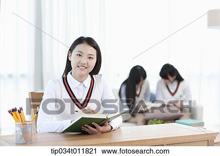 a student sitting at desk studying View Large Photo Image Stock Image - a student sitting at desk studying. Fotosearch