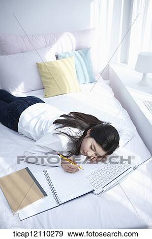 a student sleeping on bed while studying View Large Photo Image Stock Photo - a student sleeping on bed while studying. Fotosearch