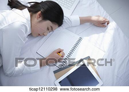 a student sleeping on bed while studying View Large Photo Image Stock Photo - a student sleeping on bed while studying. Fotosearch