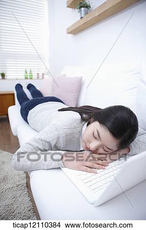 a student sleeping on bed while using laptop View Large Photo Image Picture - a student sleeping on bed while using laptop. Fotosearch