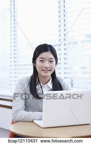 Stock Image - a student using a laptop. Fotosearch