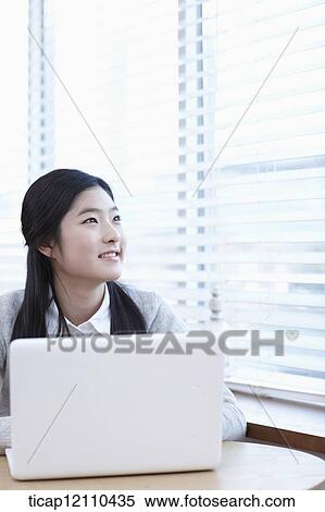 Stock Photography - a student using a laptop. Fotosearch