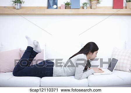 a student using laptop while lying on the bed View Large Photo Image Stock Image - a student using laptop while lying on the bed. Fotosearch