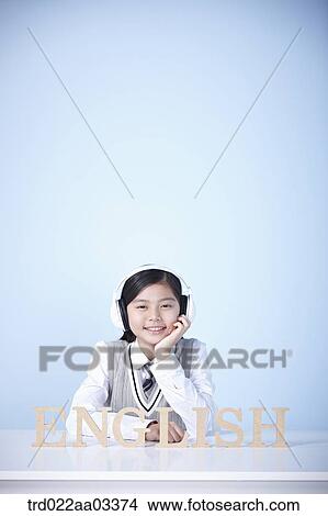 a student with a block of words saying English View Large Photo Image Picture - a student with a block of words saying English. Fotosearch