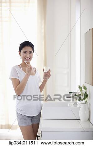 a woman brushing teeth View Large Photo Image Stock Image - a woman brushing teeth. Fotosearch