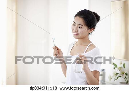 Stock Photo - a woman brushing teeth. Fotosearch