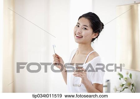 Stock Photo - a woman brushing teeth. Fotosearch