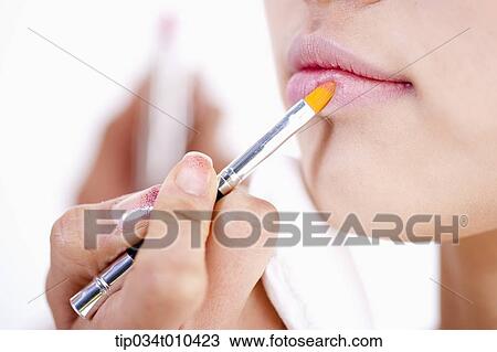 Stock Image - a woman getting professional make up. Fotosearch