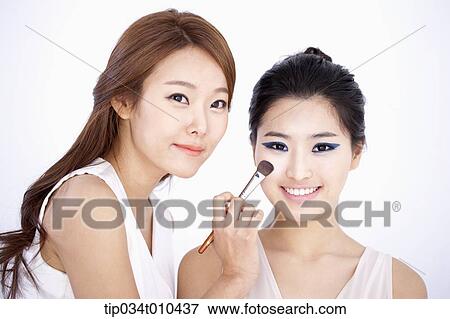 Stock Photo - a woman getting professional make up. Fotosearch