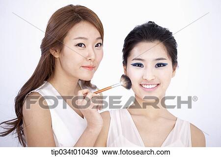 Stock Photo - a woman getting professional make up. Fotosearch