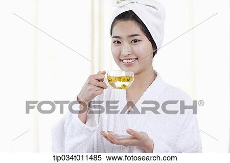 a woman in bathrobe drinking a tea View Large Photo Image Stock Photography - a woman in bathrobe drinking a tea. Fotosearch