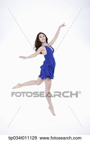 Stock Photo - a woman in blue fancy dress posing like a ballerina. Fotosearch