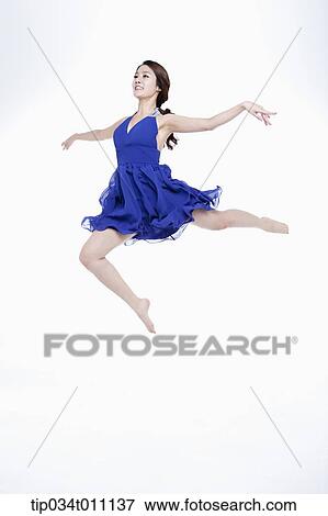 Stock Photo - a woman in blue fancy dress posing like a ballerina. Fotosearch