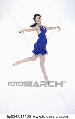Stock Photography - a woman in blue fancy dress posing like a ballerina. Fotosearch