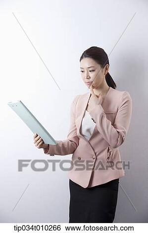 a woman in business suit holding a folder View Large Photo Image Stock Photograph - a woman in business suit holding a folder. Fotosearch