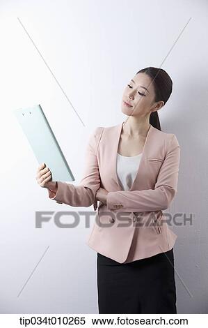Stock Photography - a woman in business suit holding a folder. Fotosearch