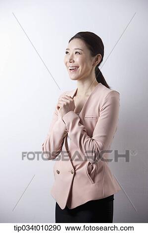 Stock Image - a woman in business suit looking excited. Fotosearch