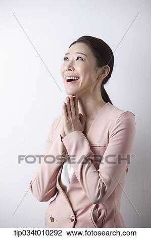 Stock Image - a woman in business suit looking excited. Fotosearch