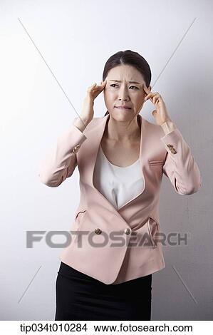 Picture - a woman in business suit looking stressed. Fotosearch