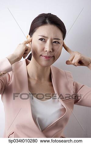 Stock Image - a woman in business suit looking stressed. Fotosearch