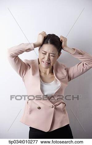 a woman in business suit looking stressed View Large Photo Image Stock Photo - a woman in business suit looking stressed. Fotosearch