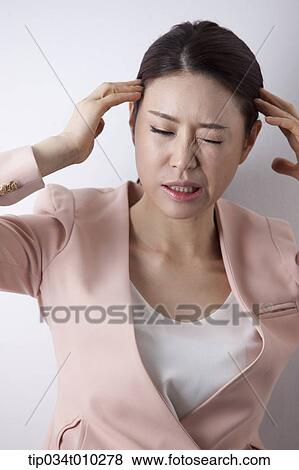 a woman in business suit looking stressed View Large Photo Image Stock Photo - a woman in business suit looking stressed. Fotosearch