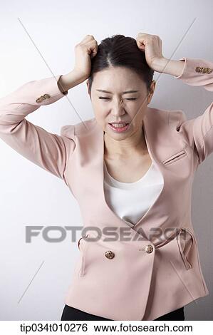 Stock Photograph - a woman in business suit looking stressed. Fotosearch