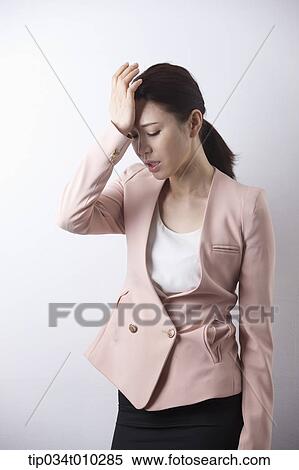 a woman in business suit looking stressed View Large Photo Image Stock Photography - a woman in business suit looking stressed. Fotosearch