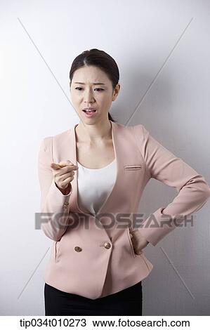 Stock Image - a woman in business suit scolding someone. Fotosearch
