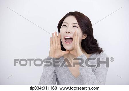 Stock Photo - a woman in grey plain shirt shouting. Fotosearch