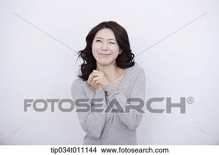 a woman in grey plain shirt smiling View Large Photo Image Picture - a woman in grey plain shirt smiling. Fotosearch