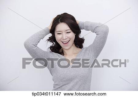a woman in grey plain shirt smiling View Large Photo Image Stock Photo - a woman in grey plain shirt smiling. Fotosearch