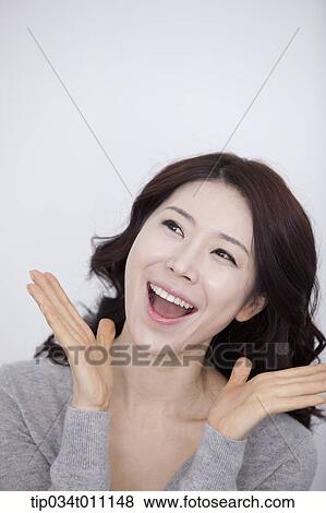 Stock Photo - a woman in grey plain shirt smiling. Fotosearch