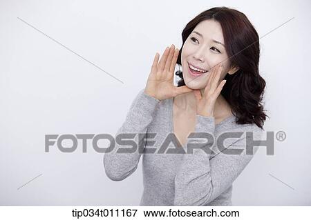 Stock Photo - a woman in grey plain shirt smiling. Fotosearch