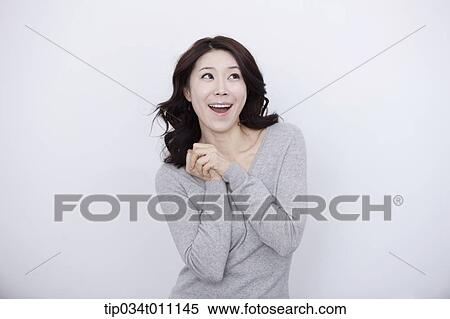 a woman in grey plain shirt smiling View Large Photo Image Stock Photography - a woman in grey plain shirt smiling. Fotosearch